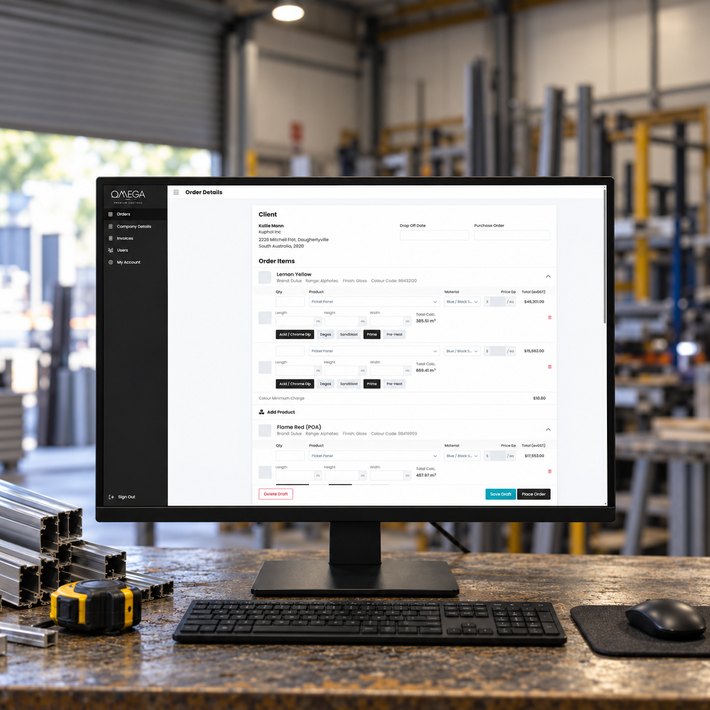 Omega Coaters client portal order form on a monitor in a fabrication workshop office